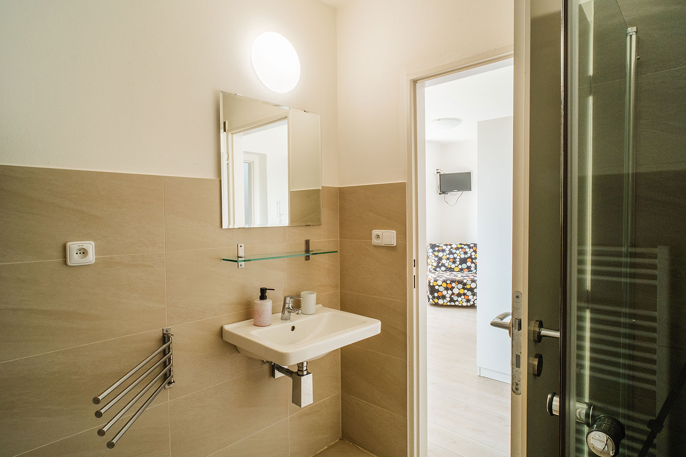 Koupelna apartmánu se sprchovým koutem a umyvadlem